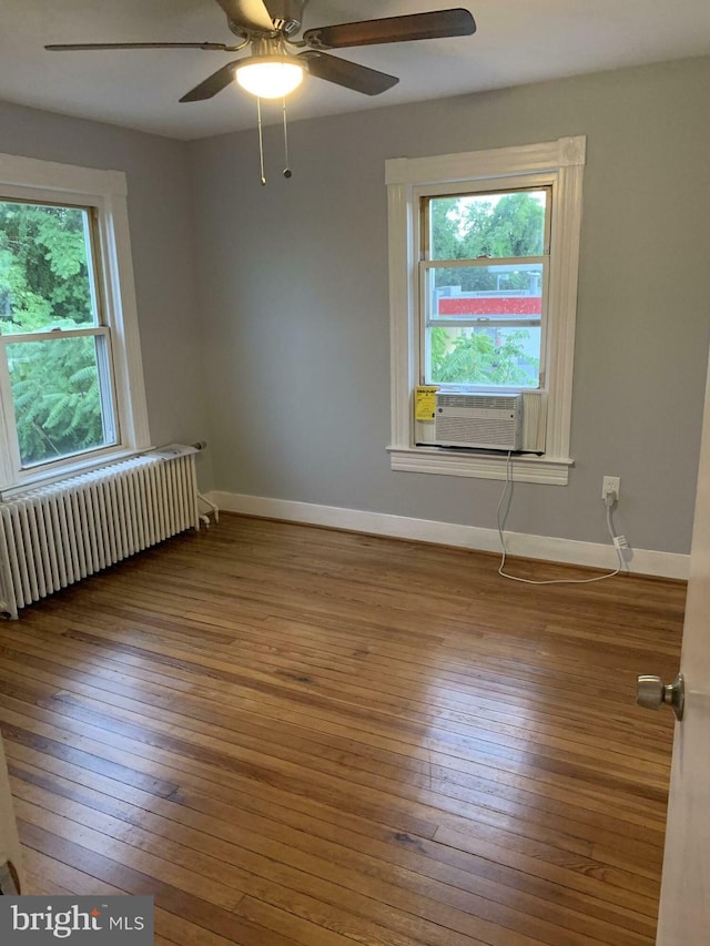 120 2nd St, Laurel, MD 20707 - empty room featuring radiator heating unit, hardwood / wood-style floors, baseboards, a ceiling fan, and cooling unit