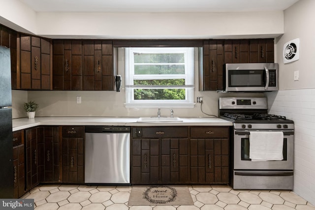 2958 Hannah Ave, Norristown, PA 19401 - kitchen featuring stainless steel appliances, a sink, and dark brown cabinets