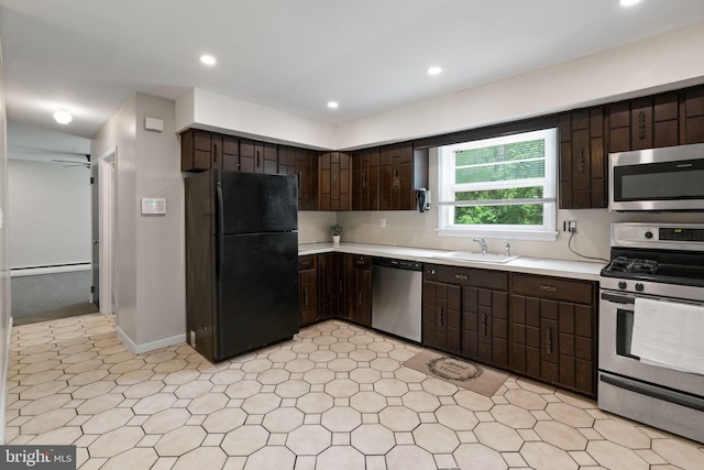 2958 Hannah Ave, Norristown, PA 19401 - kitchen featuring appliances with stainless steel finishes, dark brown cabinets, light countertops, a sink, and light floors