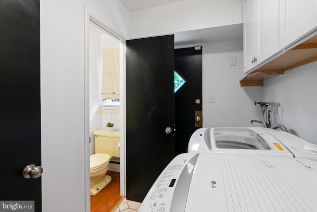 2958 Hannah Ave, Norristown, PA 19401 - laundry room with cabinet space, washing machine and clothes dryer, and tile walls