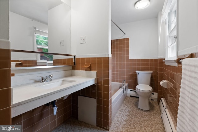 2958 Hannah Ave, Norristown, PA 19401 - full bath with toilet, tile walls, tub / shower combination, a sink, and a wainscoted wall