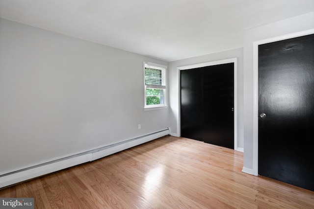 2958 Hannah Ave, Norristown, PA 19401 - unfurnished bedroom featuring baseboard heating, light wood-style flooring, and baseboards