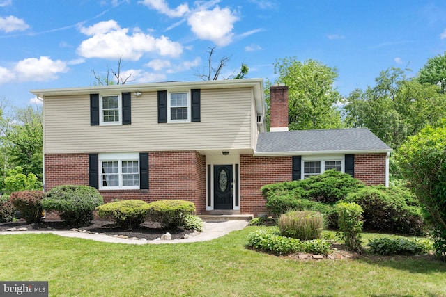 2958 Hannah Ave, Norristown, PA 19401 - colonial-style house with brick siding, a front yard, and a chimney