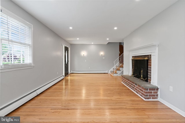 2958 Hannah Ave, Norristown, PA 19401 - unfurnished living room with a baseboard heating unit, recessed lighting, light wood finished floors, a fireplace, and stairs