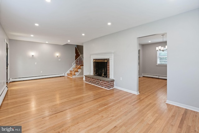 2958 Hannah Ave, Norristown, PA 19401 - unfurnished living room featuring baseboard heating, recessed lighting, light wood finished floors, stairs, and a brick fireplace