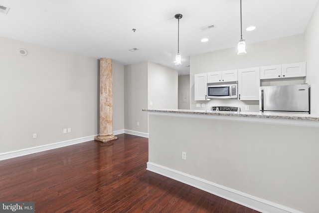 1811 Chestnut St Unit 104, Philadelphia, PA 19103 - kitchen featuring appliances with stainless steel finishes, baseboards, dark wood-type flooring, white cabinetry, and pendant lighting