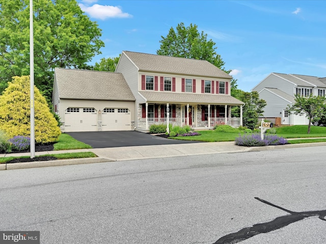 15 Behrens Dr, Palmyra, PA 17078 - colonial-style house featuring a porch, an attached garage, and asphalt driveway