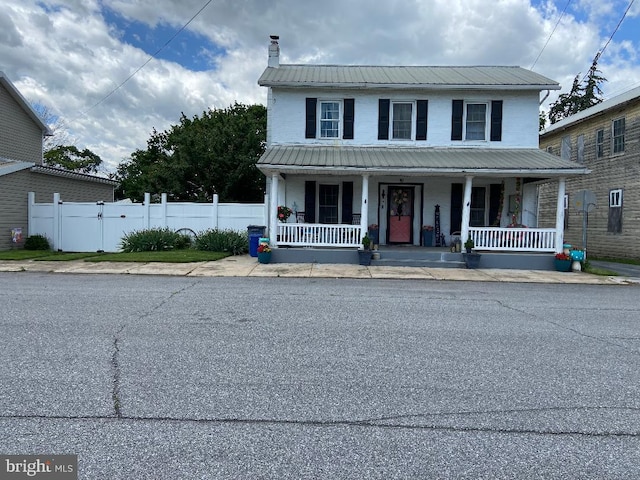 10 Whyte St, Union Bridge, MD 21791 - view of front of property featuring covered porch, metal roof, and a chimney