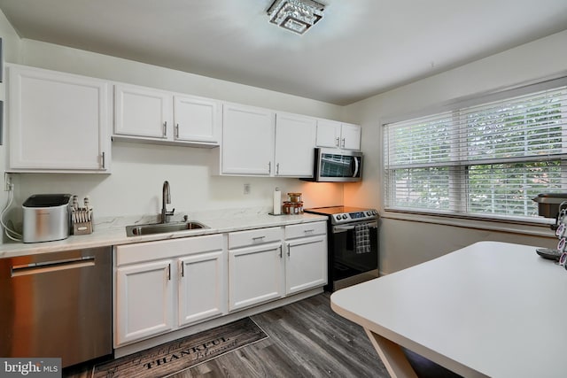 1836 Eloise Ln, Edgewood, MD 21040 - kitchen featuring appliances with stainless steel finishes, a sink, white cabinets, and dark wood-style floors