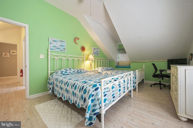 635 Sandy Point Rd, Bethany Beach, DE 19930 - bedroom featuring vaulted ceiling, light wood-type flooring, and baseboards