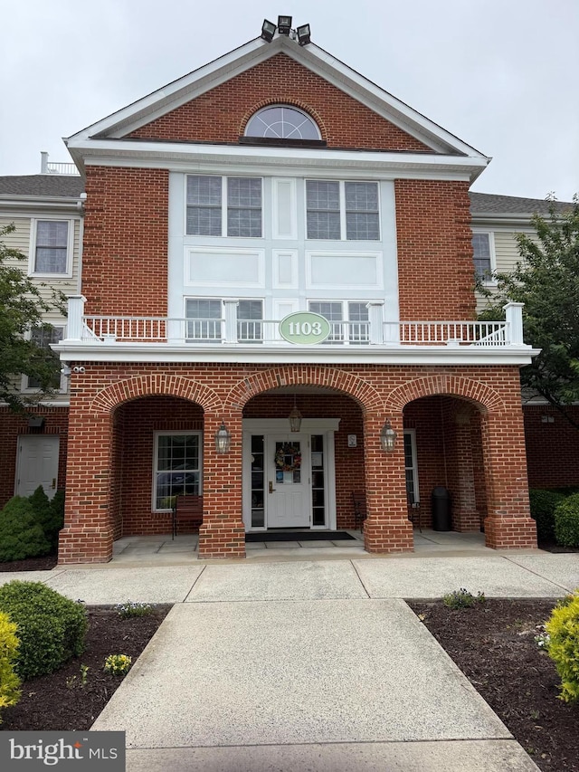 1103 S Schumaker Dr Unit C107, Salisbury, MD 21804 - view of front facade featuring brick siding, covered porch, and a balcony