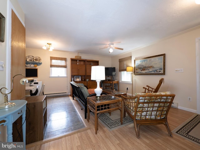 1502 Tomahawk Trl, Winchester, VA 22602 - living room with a ceiling fan, baseboard heating, light wood-style flooring, baseboards, and ornamental molding