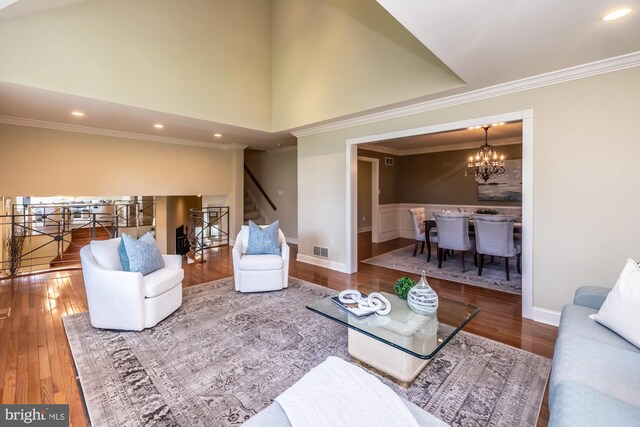 23 Street Rd, Newtown Square, PA 19073 - living area with stairs, wood finished floors, a chandelier, ornamental molding, and baseboards