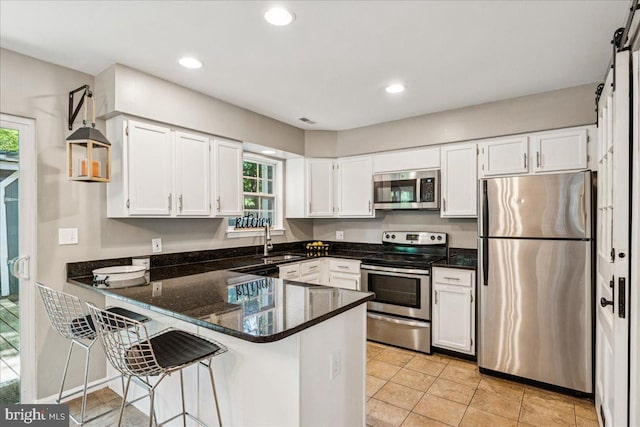 963 Breakwater Dr, Annapolis, MD 21403 - kitchen with stainless steel appliances, a sink, a peninsula, white cabinets, and recessed lighting