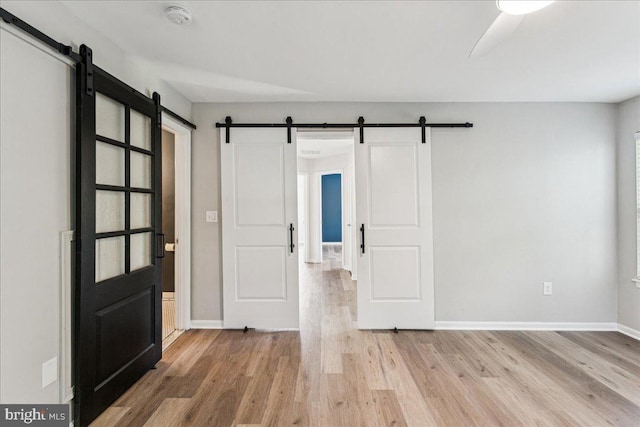 963 Breakwater Dr, Annapolis, MD 21403 - empty room with a barn door, a smoke detector, wood finished floors, and baseboards