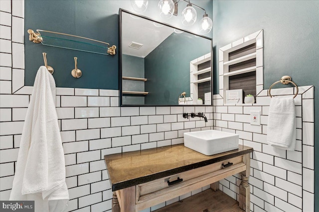 963 Breakwater Dr, Annapolis, MD 21403 - bathroom featuring vanity, wood finished floors, decorative backsplash, and tile walls