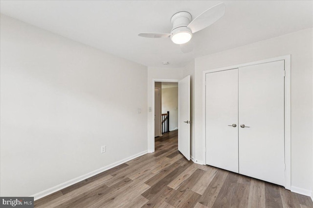 963 Breakwater Dr, Annapolis, MD 21403 - unfurnished bedroom featuring wood finished floors, a closet, baseboards, and a ceiling fan