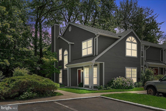 963 Breakwater Dr, Annapolis, MD 21403 - view of front facade with a chimney, uncovered parking, and roof with shingles