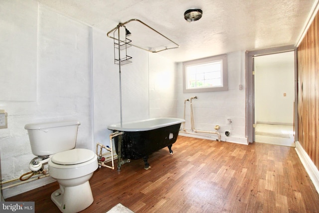 515 Burton Ave, Cambridge, MD 21613 - bathroom featuring wood finished floors, a freestanding tub, and toilet
