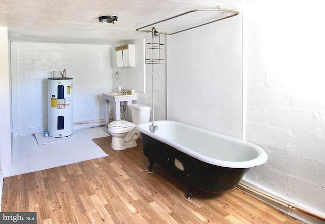 515 Burton Ave, Cambridge, MD 21613 - full bath with water heater, a soaking tub, wood finished floors, and toilet