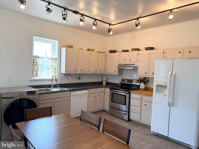 726 E Main St, Lock Haven, PA 17745 - kitchen featuring white appliances, under cabinet range hood, rail lighting, and decorative backsplash