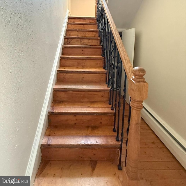 726 E Main St, Lock Haven, PA 17745 - stairs with baseboard heating and wood finished floors
