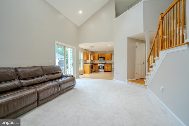 11 Adams Ct, Plainsboro, NJ 08536 - living area with light carpet, stairway, high vaulted ceiling, baseboards, and recessed lighting