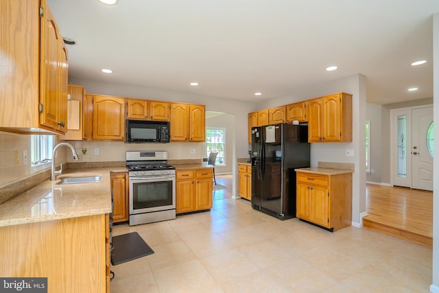 11 Adams Ct, Plainsboro, NJ 08536 - kitchen featuring black appliances, a sink, recessed lighting, light stone counters, and tasteful backsplash