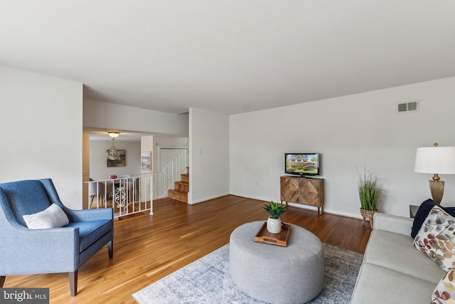 11706 Milbern Dr, Rockville, MD 20854 - living room with stairs, wood finished floors, and baseboards