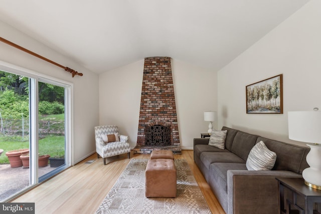 11706 Milbern Dr, Rockville, MD 20854 - living area featuring lofted ceiling, light wood finished floors, and a fireplace