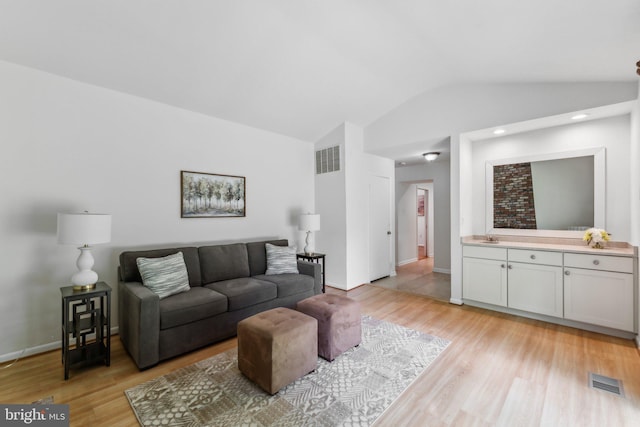 11706 Milbern Dr, Rockville, MD 20854 - living room with lofted ceiling, light wood-style flooring, and baseboards