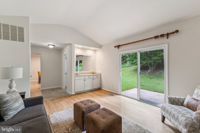 11706 Milbern Dr, Rockville, MD 20854 - living room with light wood finished floors and vaulted ceiling