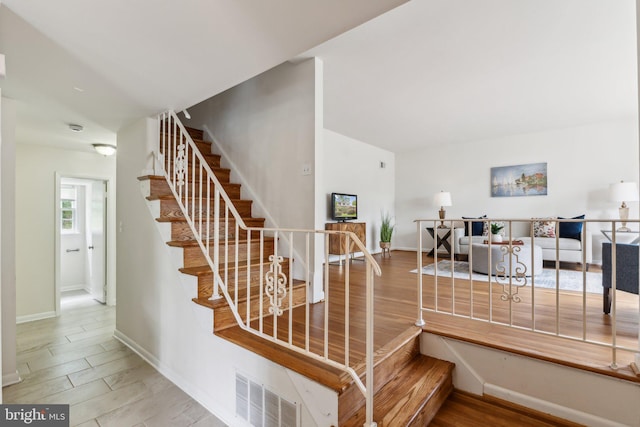 11706 Milbern Dr, Rockville, MD 20854 - staircase featuring wood finished floors and baseboards