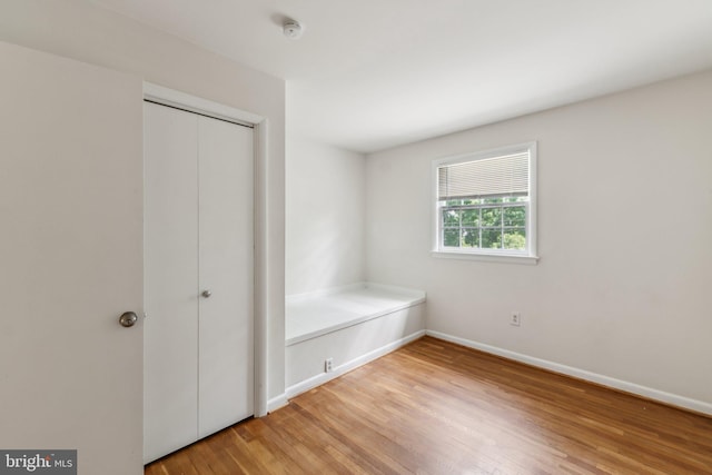 11706 Milbern Dr, Rockville, MD 20854 - unfurnished bedroom with light wood-style floors, baseboards, and a closet