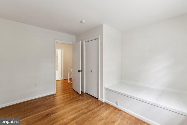 11706 Milbern Dr, Rockville, MD 20854 - unfurnished bedroom featuring light wood finished floors, a closet, and baseboards