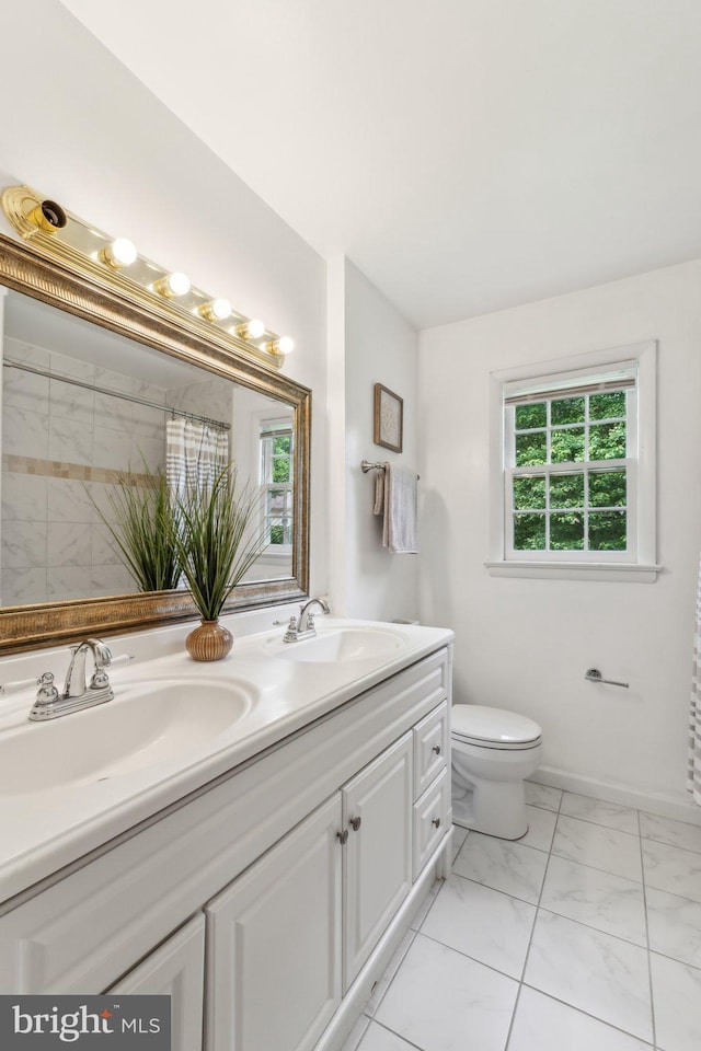 11706 Milbern Dr, Rockville, MD 20854 - full bathroom with double vanity, toilet, marble look tiles, and a shower