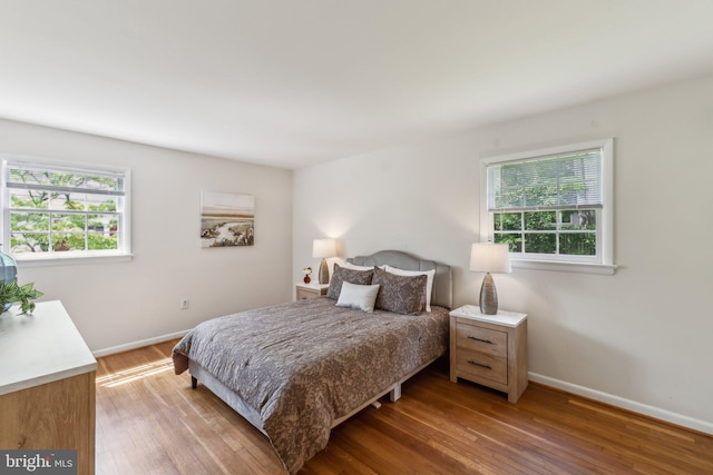 11706 Milbern Dr, Rockville, MD 20854 - bedroom featuring multiple windows, light wood-style floors, and baseboards
