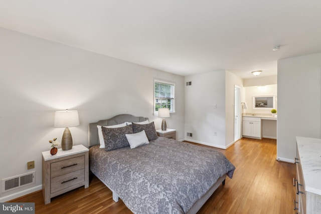 11706 Milbern Dr, Rockville, MD 20854 - bedroom with light wood-type flooring, baseboards, and connected bathroom