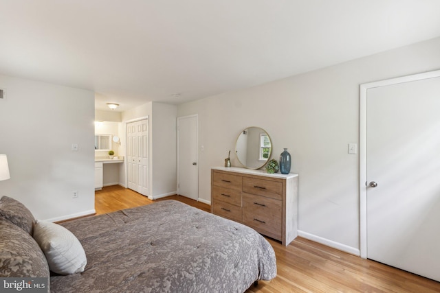 11706 Milbern Dr, Rockville, MD 20854 - bedroom with light wood-style floors, baseboards, and ensuite bath