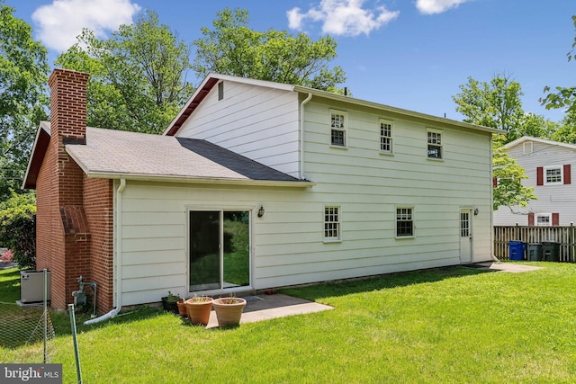 11706 Milbern Dr, Rockville, MD 20854 - back of property with a chimney, a shingled roof, and central AC unit