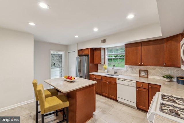 11706 Milbern Dr, Rockville, MD 20854 - kitchen featuring white appliances, a sink, tasteful backsplash, a center island, and recessed lighting