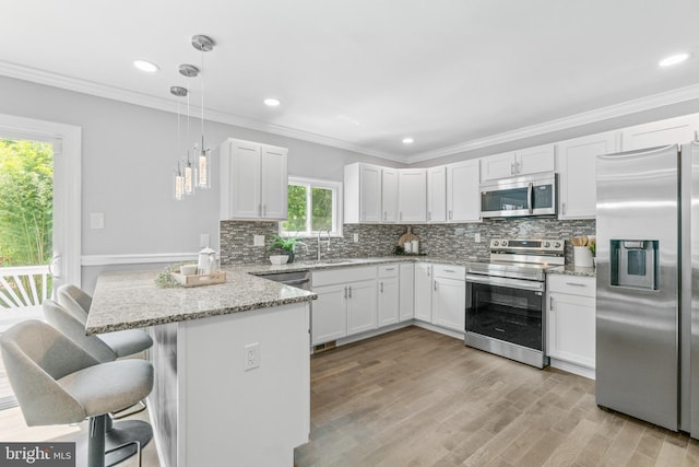 7102 Walnut Ave, Baltimore, MD 21208 - kitchen with appliances with stainless steel finishes, a peninsula, light stone countertops, tasteful backsplash, and ornamental molding