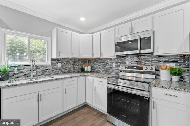 7102 Walnut Ave, Baltimore, MD 21208 - kitchen with stainless steel appliances, a sink, dark wood-type flooring, ornamental molding, and white cabinets