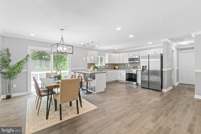 7102 Walnut Ave, Baltimore, MD 21208 - dining space featuring recessed lighting, crown molding, light wood finished floors, a chandelier, and baseboards