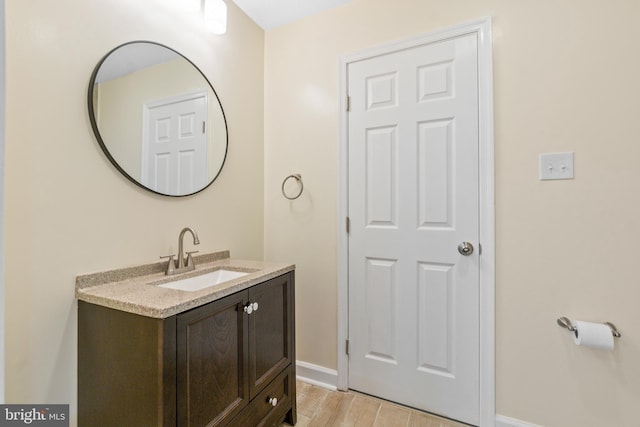 7102 Walnut Ave, Baltimore, MD 21208 - bathroom featuring vanity, baseboards, and wood finished floors