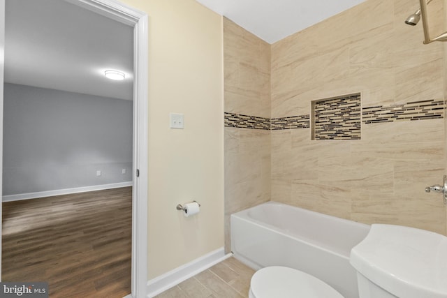 7102 Walnut Ave, Baltimore, MD 21208 - bathroom with toilet, wood finished floors, baseboards, and bathtub / shower combination