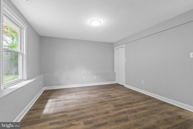 7102 Walnut Ave, Baltimore, MD 21208 - unfurnished bedroom featuring dark wood-style floors, baseboards, and a closet