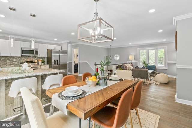 7102 Walnut Ave, Baltimore, MD 21208 - dining area with recessed lighting, baseboards, crown molding, light wood-style flooring, and a chandelier