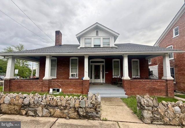 250 E E Main St, Waynesboro, PA 17268 - view of front of property featuring covered porch, a chimney, brick siding, and a shingled roof
