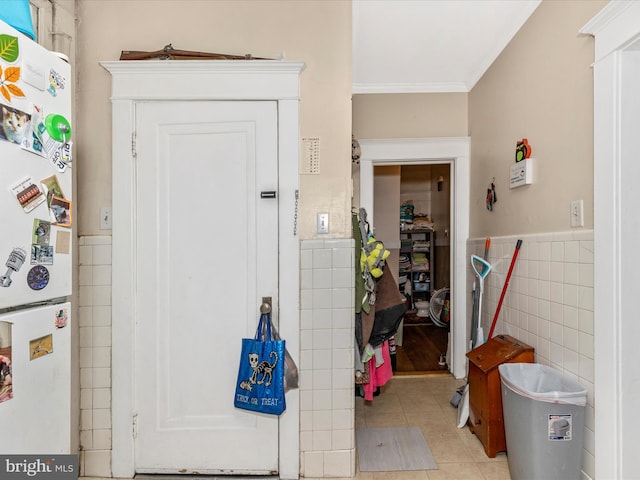 250 E E Main St, Waynesboro, PA 17268 - hallway featuring tile walls, light tile patterned floors, crown molding, and wainscoting